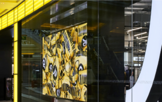 Eingangsbereich und Fassadengestaltung einer JD-Sports-Filiale mit großem JD-Logo im Einkaufszentrum