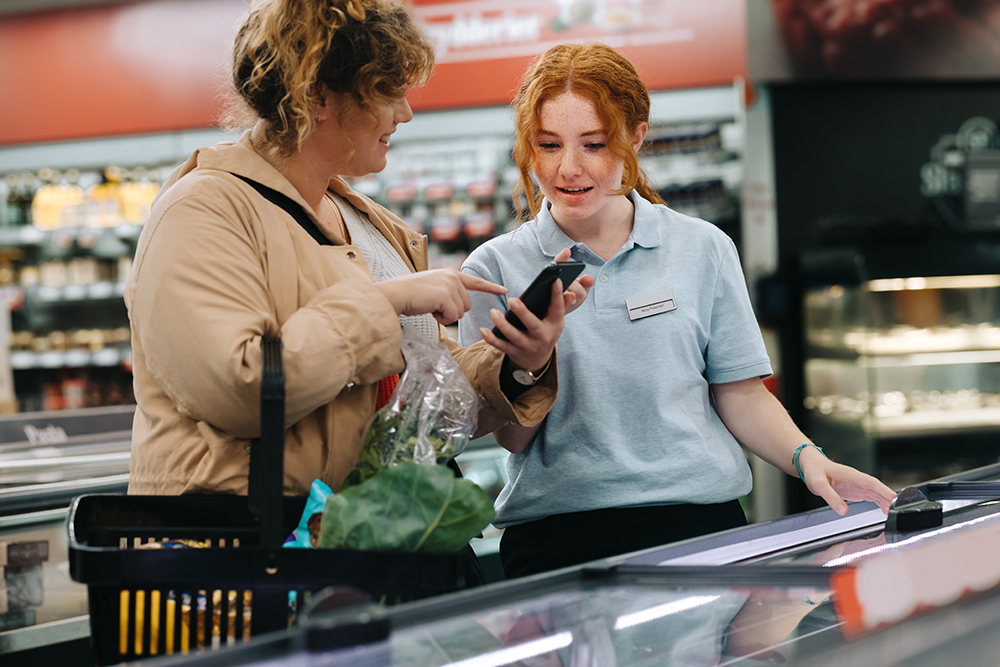 Grocery,Store,Worker,Assisting,Female,Shopper.,Female,Customer,Showing,Her
