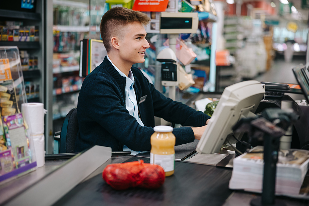Man,Working,At,Grocery,Store,Checkout.,Young,Worker,On,Holiday